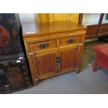 20TH CENTURY SMALL CUPBOARD WITH TWO DRAWERS OVER TWO DOORS IN A CHINESE STYLE, 80CM WIDE