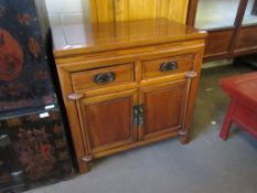 20TH CENTURY SMALL CUPBOARD WITH TWO DRAWERS OVER TWO DOORS IN A CHINESE STYLE, 80CM WIDE