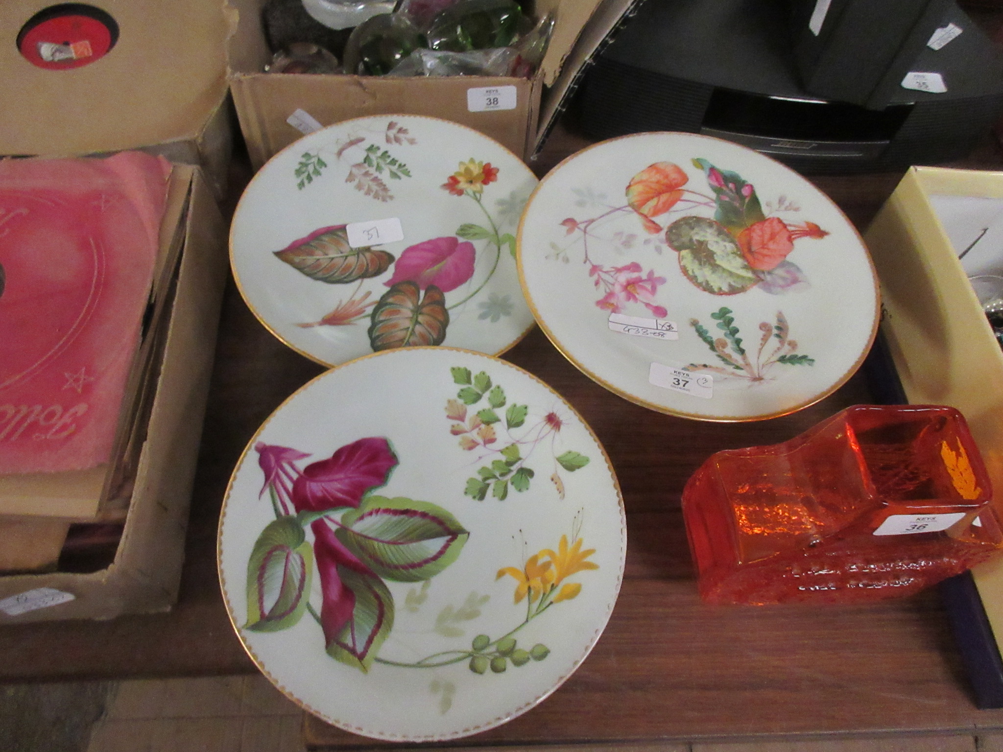 SET OF THREE HAND DECORATED TAZZAS WITH FLORAL DECORATION AND GILT RIMS, NUMBERED TO BASES