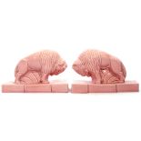 Pair of unusual pink pottrey studies of mythological bulls standing on integral bases, 11cm high