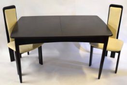 Retro style black painted extending dining table and chairs, the table with two leaves and six tall