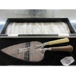 CASE CONTAINING SILVER PLATED TROWEL AND FORK, THE TROWEL ENGRAVED “PRESENTED TO R W BRO HOWARD G