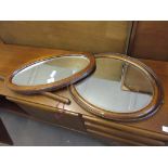 TWO OVAL WALL MIRRORS