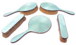 George V silver and enamel dressing table set, to include a hand mirror and two hair brushes, two