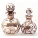 Two graduated overlaid globular clear glass scent bottles and stoppers, one stamped sterling deposit