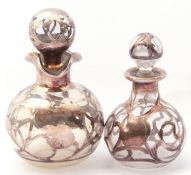 Two graduated overlaid globular clear glass scent bottles and stoppers, one stamped sterling deposit