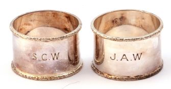 Cased pair of silver napkin rings, the rims applied with a leaf and scroll design, engraved J A W