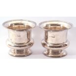 Pair of silver bottle holders of campana shape, plain polished form, reeded rims (loaded), hall