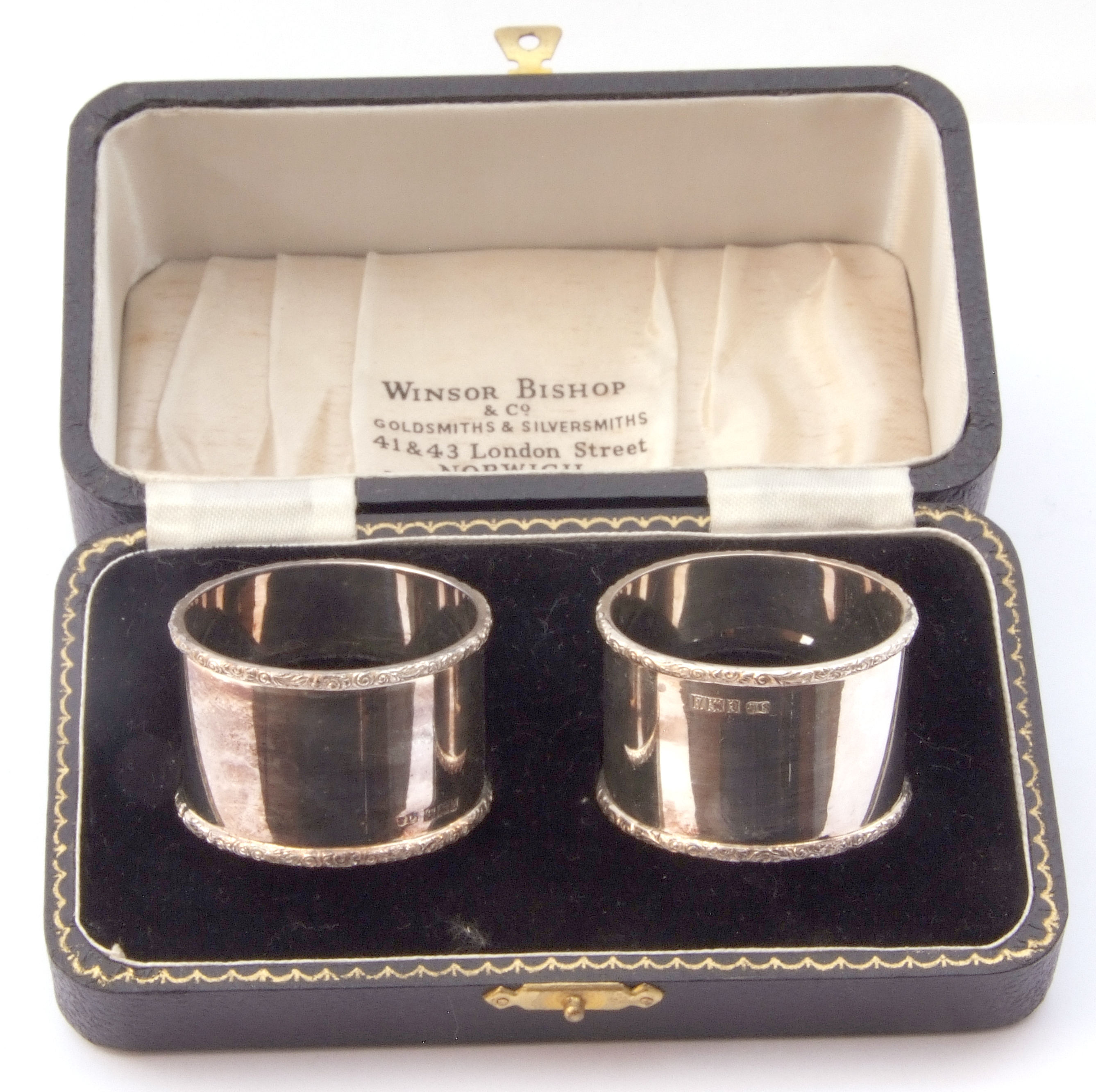 Cased pair of silver napkin rings, the rims applied with a leaf and scroll design, engraved J A W - Image 2 of 2