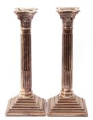 Pair of modern silver Corinthian column candlesticks on stepped beaded loaded bases with