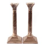 Pair of modern silver Corinthian column candlesticks on stepped beaded loaded bases with