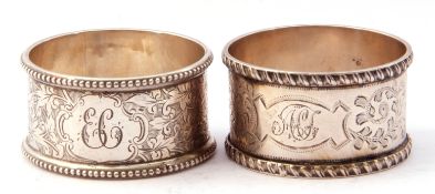 Case of two silver serviette rings both chased and engraved with foliate design, one with beaded