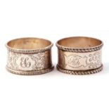 Case of two silver serviette rings both chased and engraved with foliate design, one with beaded
