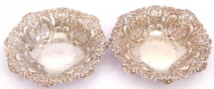 Pair of Edward VII silver bon-bon dishes of circular form, pierced and embossed with scrolls etc,