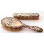 Mixed Lot: two silver backed dressing table brushes, both embossed with cherubs and scrolls etc,