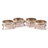 Late Victorian set of four cauldron salts each with gadrooned rims, foliate repousse decoration on