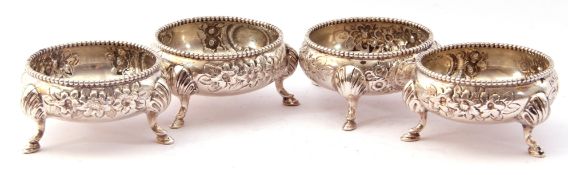 Late Victorian set of four cauldron salts each with gadrooned rims, foliate repousse decoration on