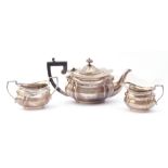 George V three piece silver tea set of oval shaped form with angular handles, comprising teapot,