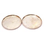 Pair of hall marked silver small trays of plain circular form, hall marks rubbed, makers mark