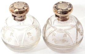 Pair of Edward VII cut glass spherical scent bottles with hallmarked silver hinged lids,