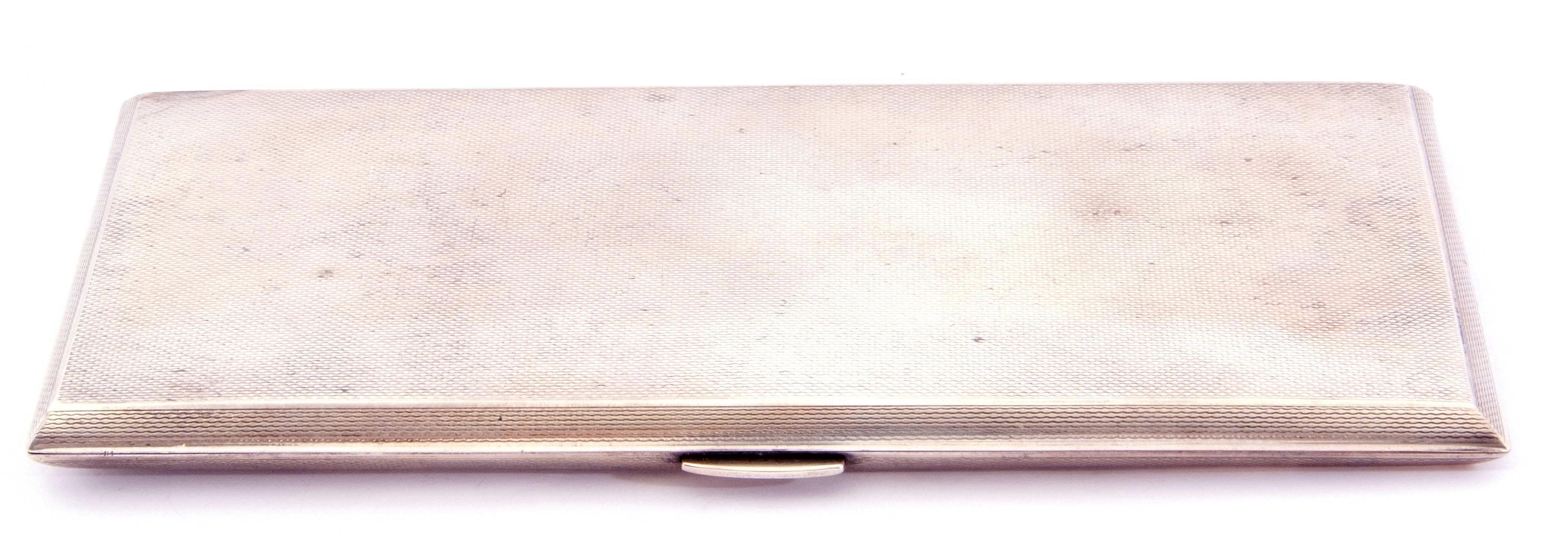 Mid 20 century large silver cigarette case of rectangular form with engine turned decoration, push