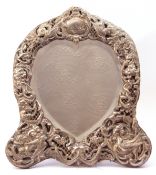 Victorian mirror in a silver frame, the heart-shaped bevelled mirror within an elaborately