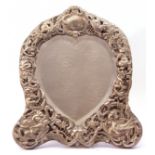 Victorian mirror in a silver frame, the heart-shaped bevelled mirror within an elaborately