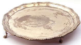 George VI salver of plain design, shaped circular form with gadrooned wavy edge supported on four