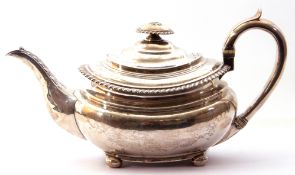 George IV tea pot of compressed rectangular design, having gadrooned rim, leaf capped spout and