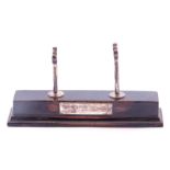Ebonised and silver pen holder, rectangular step ebonised base with two silver rowlocks and engraved