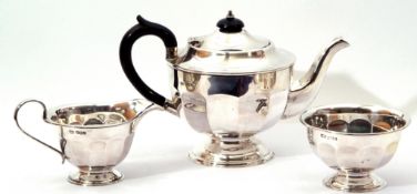 George V silver three-piece tea set, comprising of teapot of circular panel form, matching