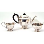 George V silver three-piece tea set, comprising of teapot of circular panel form, matching