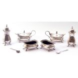 A six-piece silver condiment set comprising two hinged lidded mustards and liners, two open salts