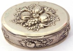 Vintage metal oval tobacco box, the lid and sides decorated with fruit and leaves etc, 9.5 x 7cm