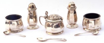 George V five piece silver cruet set of panel design to include a lidded hinged mustard and liner,