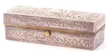 Victorian silver on metal curling tongs box of rectangular form, embossed and chased with scrolls,