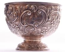 Late Victorian silver pedestal rose bowl embellished with a chased floral and scroll design on a