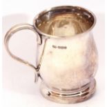 George VI silver mug of plain baluster shape, reeded handle to a raised spreading foot, 8 cm high,