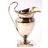 Small late Victorian cream jug of helmet shape to a square foot, having looped handle and reeded