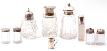Mixed lot. seven glass & silver lidded peppers, a cut glass cylindrical scent with screw on lid,