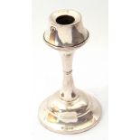 George V silver candlesticks, the inverted sconce on a waisted stem on a spreading foot (loaded),