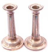 Pair of George V small candlesticks, panelled columns to stepped circular bases (loaded), Birmingham