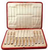 Cased set of George V dessert cutlery, six forks and knives, the fluted handles Sheffield 1917,