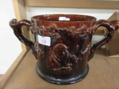 LARGE TREACLE GLAZED LOVING CUP WITH MOULDED DECORATION THROUGHOUT, HEIGHT APPROX 17CM