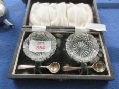 CASED PAIR OF CUT GLASS SALTS, EACH WITH ITS OWN SILVER PLATED SPOON