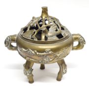 Chinese brass censer and stand mounted on three tripod feet, the cover with pierced decoration of