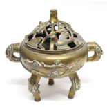 Chinese brass censer and stand mounted on three tripod feet, the cover with pierced decoration of