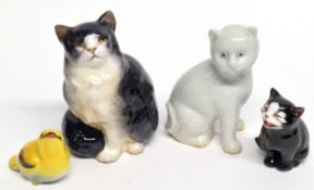 Royal Doulton model of a cat together with a small yellow bird, further novelty cat and a white