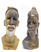 Two African carved heads of a man and a lady from the Mashona tribe, one signed R Mugari to base (