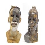 Two African carved heads of a man and a lady from the Mashona tribe, one signed R Mugari to base (